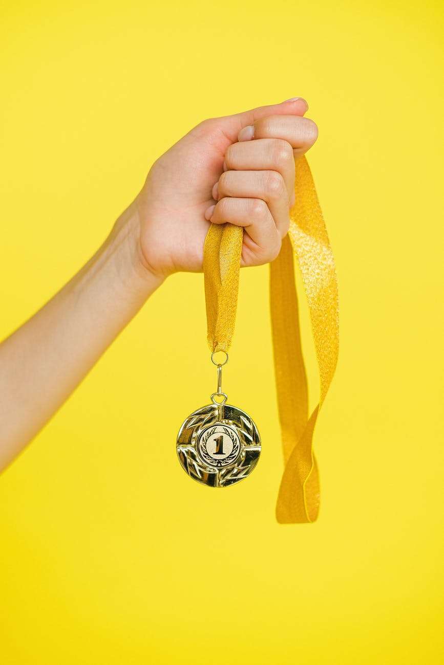 person holding a gold medal
